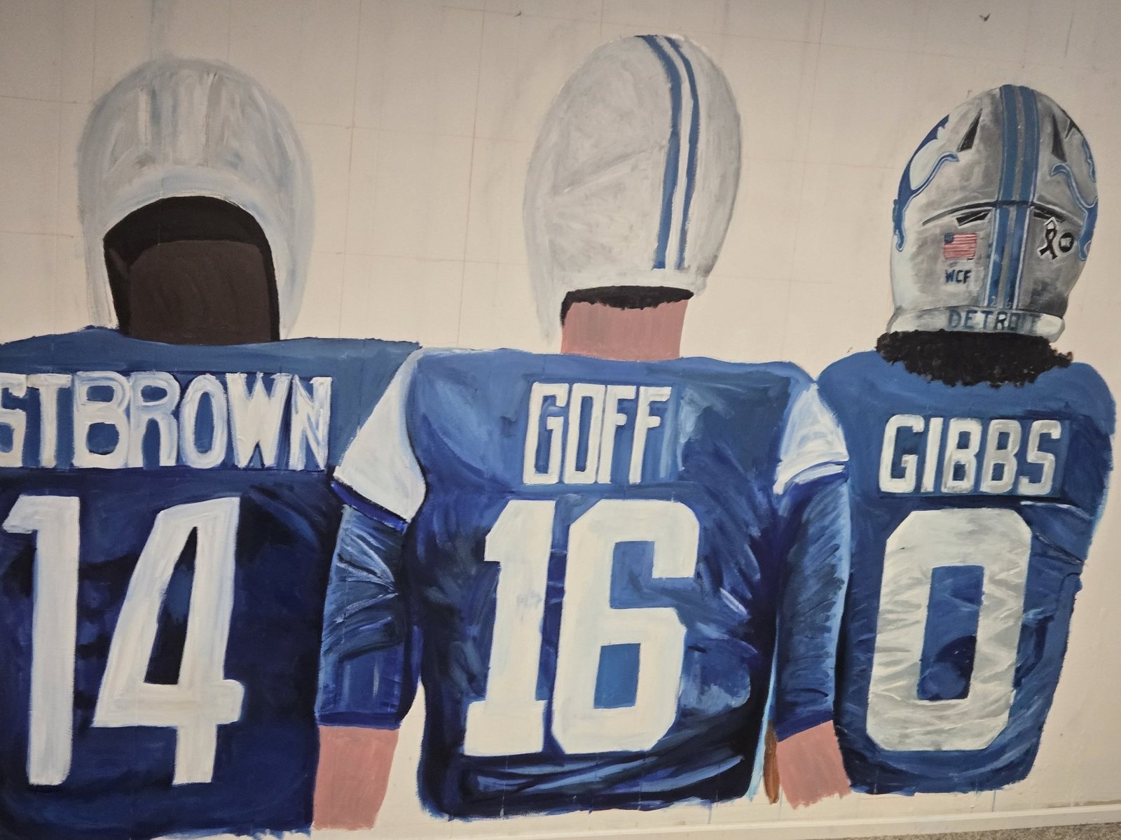 Detroit Lions wall mural showing St. Brown, Goff and Gibbs jerseys